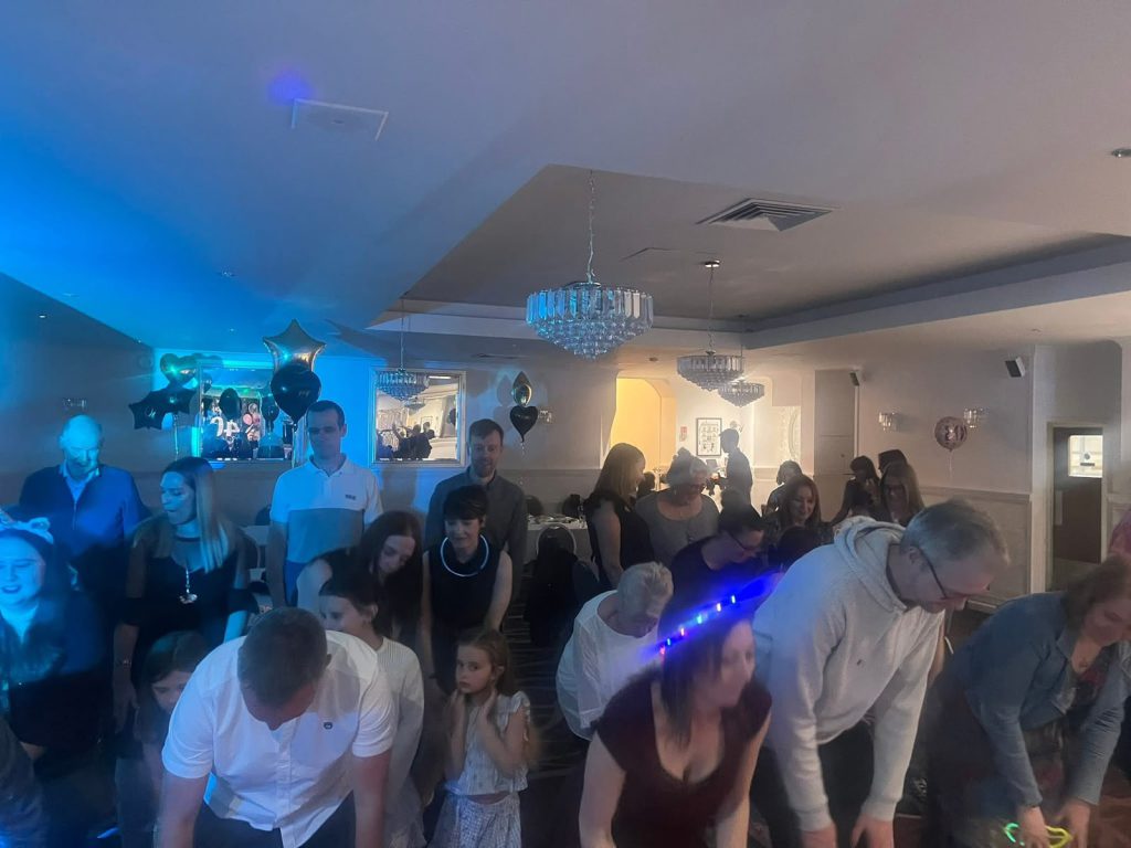 Guests of all ages on the dance floor at a family celebration